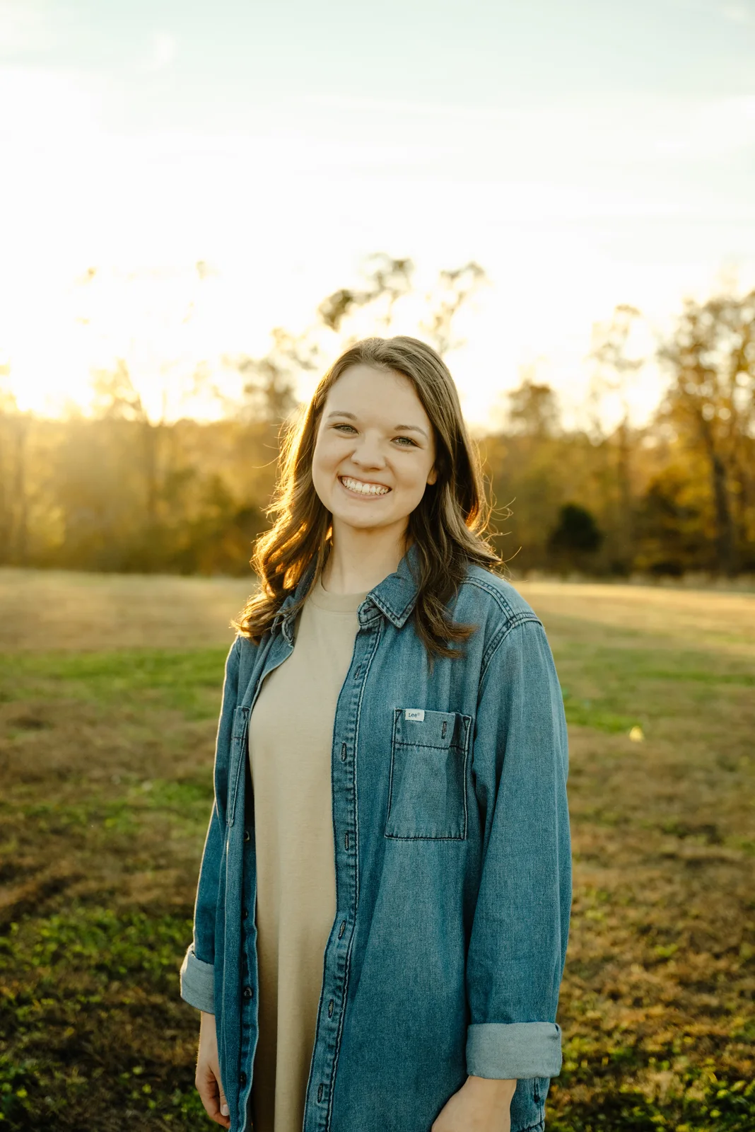 Mikayla Rich standing in a field at sunset