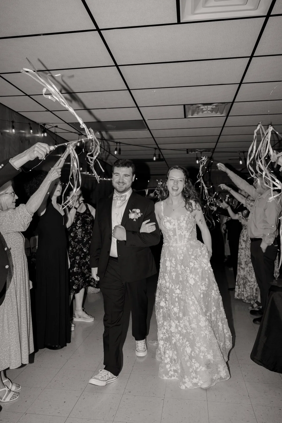A couple’s exit through ribbons, in black and white
