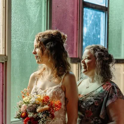 A bride and her mother by stained glass